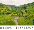 Aerial view of a scenic mountain valley with a winding road through the rugged landscape of Brecon Beacons National Park in Wales, United Kingdom Powys, Wales - 28 August 2026. 143743897