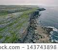 Aerial view of The Burren, a dramatic limestone landscape in County Clare, western Ireland, featuring rugged rocky terrain, green fields and distinctive karst Clare, Ireland - 28 August 2026 143743898