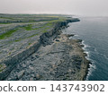 Aerial view of The Burren, a dramatic limestone landscape in County Clare, western Ireland, featuring rugged rocky terrain, green fields and distinctive karst Clare, Ireland - 28 August 2026 143743902