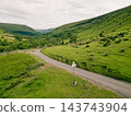Aerial view of a scenic mountain valley with a winding road through the rugged landscape of Brecon Beacons National Park in Wales, United Kingdom Powys, Wales - 28 August 2026. 143743904