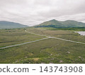 Aerial view of Lough Bofin in the Connemara region of County Galway, Ireland, surrounded by rugged mountains, green countryside and tranquil waters Galway, Ireland - 28 August 2026. 143743908