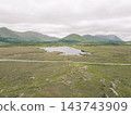 Aerial view of Lough Bofin in the Connemara region of County Galway, Ireland, surrounded by rugged mountains, green countryside and tranquil waters Galway, Ireland - 28 August 2026. 143743909