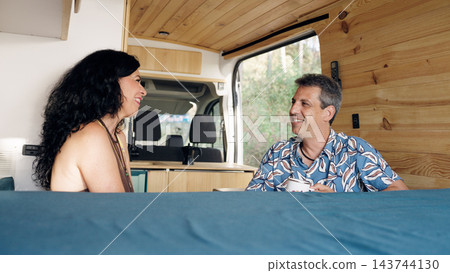 Mature couple enjoying travel and freedom in camper van Mature couple enjoying travel and freedom in camper van 143744130