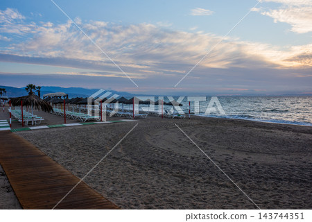 sunrise on the beach with a sunbathing bed in Spain, Almeria sunrise on the beach with a sunbathing bed in Spain, Almeria 143744351