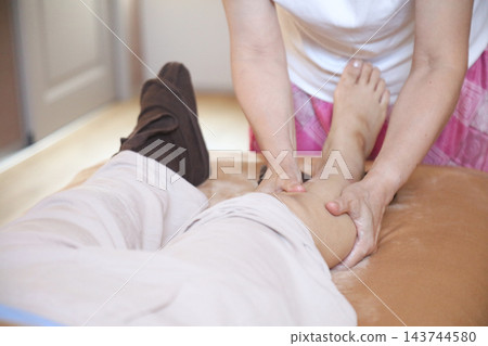 A woman with a foot massage A woman with a foot massage 143744580