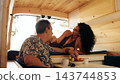 Mature couple enjoying fruits inside camper van 143744853