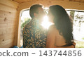 Mature couple sharing romantic moment inside camper van 143744856