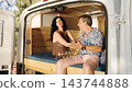 Mature couple enjoying camper van road trip lifestyle 143744888
