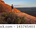 Boy Hiking at Sunset on Devils Garden Trail, Utah 143745403
