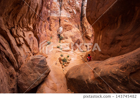Young Hiker Exploring Fiery Furnace Trail in Utah Young Hiker Exploring Fiery Furnace Trail in Utah 143745482