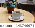Herbal tea and flowers placed on a cafe table 143746674
