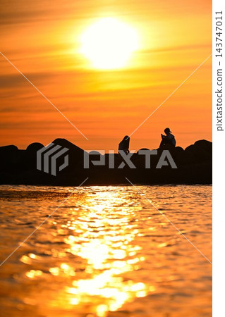夕陽西下,海岸線上映一個人的剪影(新潟縣新潟市) 夕陽西下,海岸線上映一個人的剪影(新潟縣新潟市) 143747011