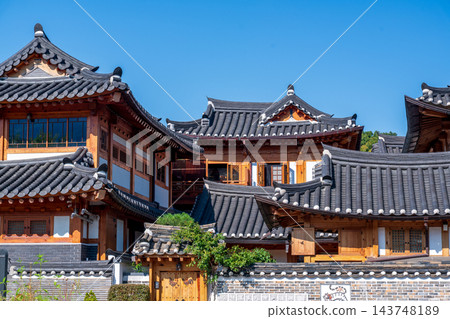 Traditional Korean Hanok Houses and Tiled Roofs against Bukhansan Mountain in Eunpyeong Hanok Village, Seoul 143748189