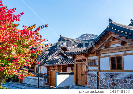 Traditional Korean Hanok Houses and Tiled Roofs against Bukhansan Mountain in Eunpyeong Hanok Village, Seoul Traditional Korean Hanok Houses and Tiled Roofs against Bukhansan Mountain in Eunpyeong Hanok Village, Seoul 143748193