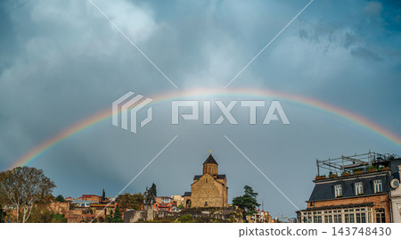 Rainbow arching over Metekhi Church and colorful old town houses on a cliff in Tbilisi, Georgia Rainbow arching over Metekhi Church and colorful old town houses on a cliff in Tbilisi, Georgia 143748430