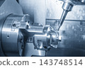 Automotive parts production on a multi-tasking CNC machine using a ball nose end mill in a blue tone scene 143748514