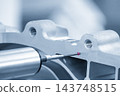 Multi-axis CMM machine measuring aluminum parts with a touch probe in a blue tone scene 143748515