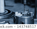 Internal thread making process on a  milling machine using a tapping tool in a blue tone scene 143748517