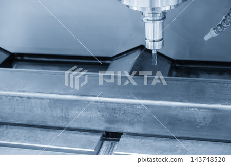 CNC milling machine cutting a metal steel pipe with a flat nose end mill tool in a light blue tone 143748520