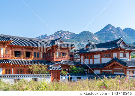 Traditional Korean Hanok Houses and Tiled Roofs against Bukhansan Mountain in Eunpyeong Hanok Village, Seoul 143748546