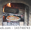 charcoal oven, topped with delicious ingredients and melted cheese, creating an irresistible, mouthwatering meal. 143748743