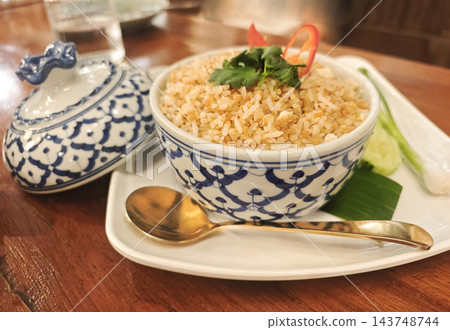Traditional Thai salt fried rice served in an authentic blue and white porcelain bowl. Traditional Thai salt fried rice served in an authentic blue and white porcelain bowl. 143748744