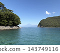 Mount Fuji can be seen over the sea and the coastal cliffs covered with forests in West Izu. 143749116