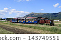 A local train running through a rural area. 143749551