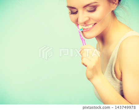 Woman brushing cleaning teeth Woman brushing cleaning teeth 143749978