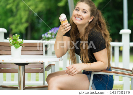Young woman eating ice cream 143750179