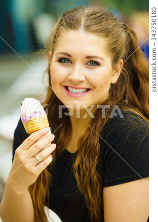 Young woman eating ice cream Young woman eating ice cream 143750180
