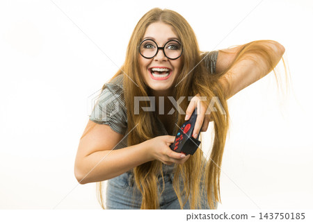 Gamer woman holding gaming pad Gamer woman holding gaming pad 143750185