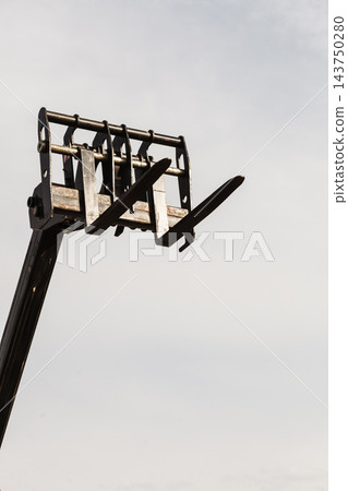 Bucket lift with blue sky in background 143750280