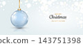 Glossy light blue Christmas bauble with gold ribbon and holiday text on a pale bokeh background. 143751398
