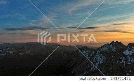 Rocky snow mountains at sunset aerial Rocky snow mountains at sunset aerial 143751451