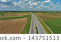 Aerial view of highway crossing green agricultural fields 143751513