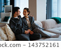Couple enjoying cozy moment together in modern living room setting 143752161