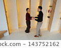 Couple enjoying a joyful dance in a contemporary indoor space 143752162