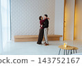 Romantic couple shares a tender moment in a modern interior space 143752167