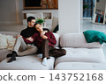 Cozy couple relaxing together on a comfortable couch at home 143752168