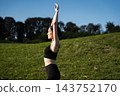 Morning yoga practice in a serene park with clear blue skies 143752170
