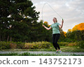 Skipping rope workout in a serene park during golden hour 143752173