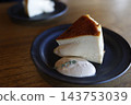 A cross-section of a melting cheesecake. A golden brown color and rich texture. 143753039