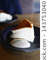 A cross-section of a melting cheesecake. A golden brown color and rich texture. 143753040