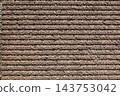 Brown background. Horizontal striped grooves and a rough, uneven texture. 143753042