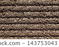 Brown background. Horizontal striped grooves and a rough, uneven texture. 143753043