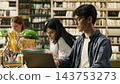 Laptop, student and studying as young man with glasses works on a computer beside fellow readers. Research, digital learning and academic productivity support coursework in a library. 143753273