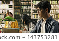 Student, laptop and research as young man with glasses concentrates on a computer at a library desk. Academic work, digital literacy and independent study connect technology with coursework. 143753281
