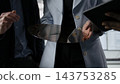 Semiconductor, silicon wafer and inspection as colleagues hold a patterned wafer and examine its surface. Quality control, materials research and manufacturing guide technical evaluation in factory. 143753285