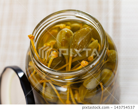 Glass jar with pickled green capers Glass jar with pickled green capers 143754537